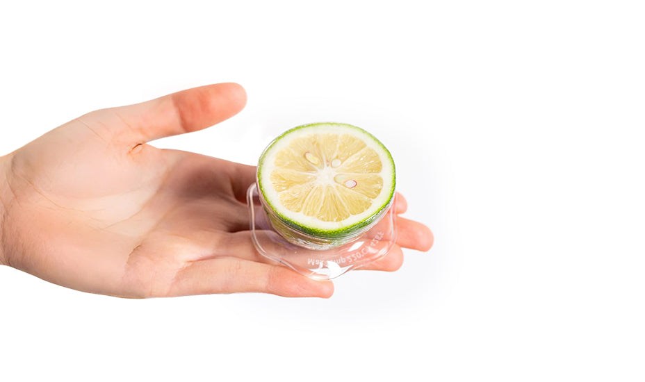 Hand holding a DeliOne Flex'n Fresh Stretch Lid covering half a lemon
